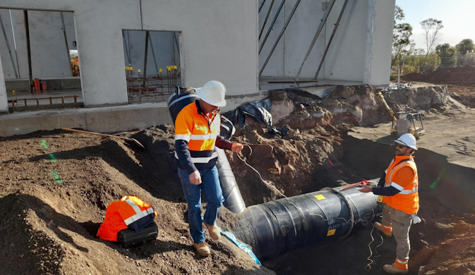 Construction workers working on an exposed pipeline