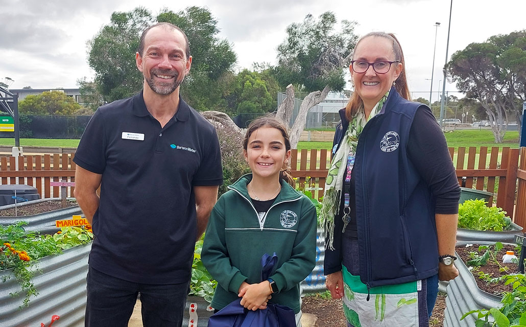 Barwon Water Education Officer Fernando Garcia, Mackenzie Fraser and garden specialist Kellie Clark in the Our Lady Star of the Sea Primary School vegetable garden.